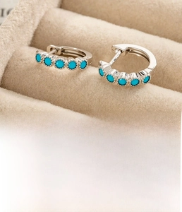 Detailed macro of vintage silver hoops with five blue zircons and 10mm inner diameter