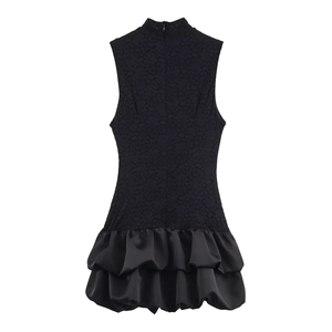 Back view of black sleeveless mini dress with lace bodice and satin ruffled hemline