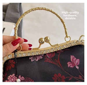 Detail of vintage shell bag with floral embroidery and rhinestone encrusted gold clasp
