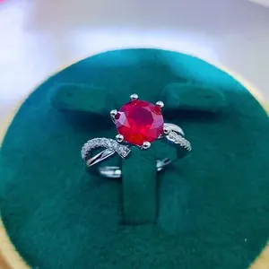 Close-up of a 2ct red ruby ring in a green velvet box with intricate six-prong setting