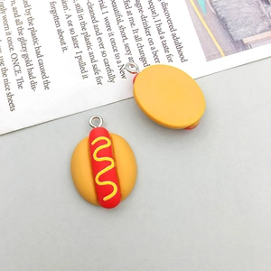 Macro detail of resin hot dog charms showing front and back views for DIY crafts