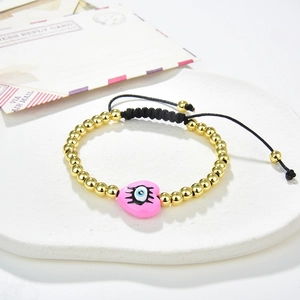 Handmade bead bracelet with golden copper beads and pink heart evil eye charm