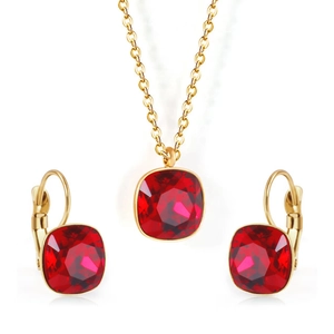 Close-up of golden stainless steel jewelry set featuring square-cut red gemstones