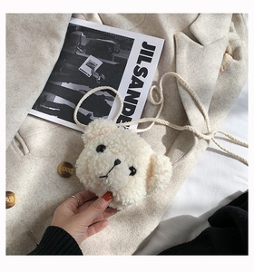 Detail of cute bear-shaped crossbody bag in cream faux shearling with soft plush texture