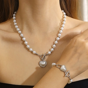 Detail of pearl chain necklace and bracelet set with shell heart charms and OT toggle clasp