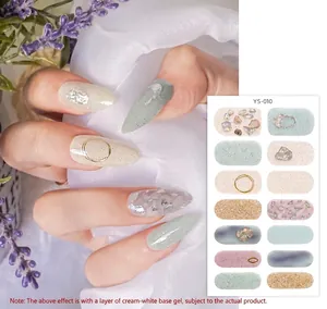 Detail of floral nail wraps with lavender accents and golden sequin embellishments