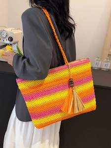 Rainbow striped straw tote bag with tassels and wooden beads for summer beach vacations
