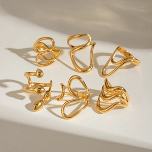 Modern 6-piece liquid gold stackable rings set with abstract fluid melt metal shapes