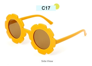 Side view of yellow flower-shaped kids sunglasses with brown lenses and plastic frame