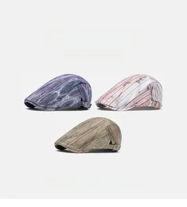 Detail view of multi-color striped flat caps showing breathable fabric and side metal buckles