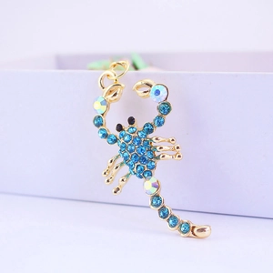 Crystal rhinestone scorpion keychain with blue stones and golden metal animal pendant