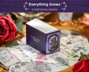 Detail of vintage flower and butterfly scrapbook paper stickers in a purple box