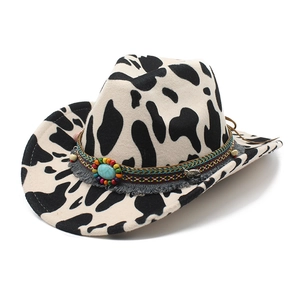 Western cowboy hat with black and white cow print, ethnic beaded band, and fringe details