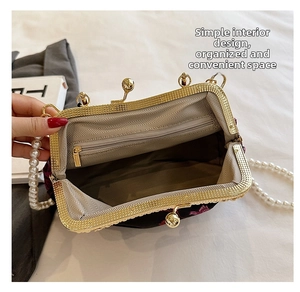 Macro view of vintage shell bag interior with striped lining and pearl handle