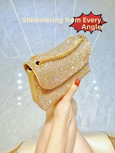 Detailed macro of a champagne gold rhinestone shoulder bag with crystal wave patterns