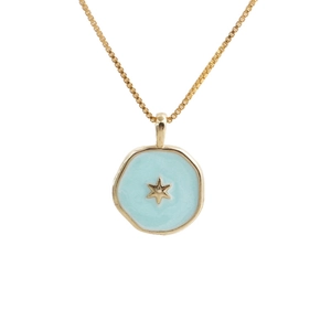 Gold-plated necklace with light blue enamel round star pendant on a white background