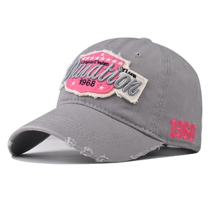 Detailed view of distressed gray cotton baseball cap with 3D embroidery patch