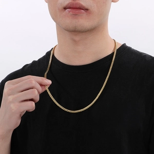 Detail of gold Franco chain necklace on male model showing heavy weave and metal texture