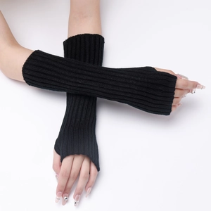 Detail view of black knitted fingerless arm warmers showing long striped texture and fit
