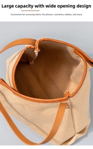 Top view of large woven canvas tote bag showing spacious interior and brown leather trim