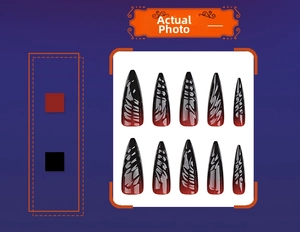 Detail of long stiletto press-on nails with 3D texture and black-red ombre gradient