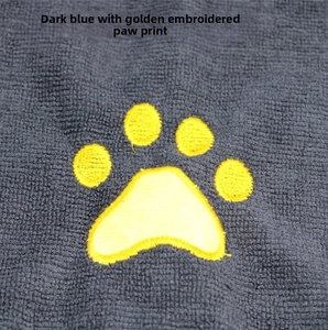Detailed macro view of navy blue coral fleece fabric with a golden dog paw embroidery