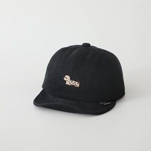 Detail of a black cotton kids baseball cap with cute dachshund embroidery and woven side label