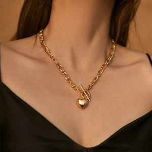Detail of 18K gold plated brass heart pendant with stylish toggle clasp on model