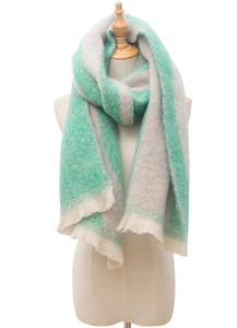 Detail of mint green and beige striped bouclé scarf with soft fuzzy texture and fringes