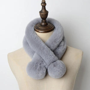Chic grey faux rabbit fur scarf with decorative pom-poms on a wooden mannequin