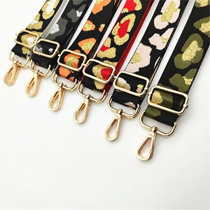 Detailed view of adjustable leopard print bag straps with shiny gold metal buckles