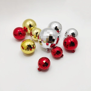 Red, gold and silver disco ball Christmas ornaments in various sizes on white background