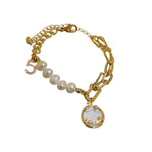 Gold-tone freshwater pearl bracelet with zircon smiley face and number 5 pendant