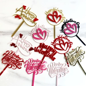 Collection of acrylic Valentine's Day cake toppers in red and gold for party decor