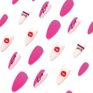 Matte neon pink press-on nails with love letters and red lip prints in long stiletto shape