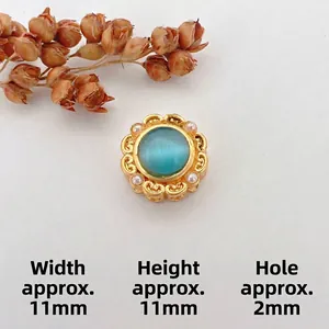 Detail of 11mm golden flower charm with blue opal and small white pearls for jewelry DIY