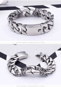 Detail of vintage carved Cuban link bracelet with engraved patterns and secure slot clasp