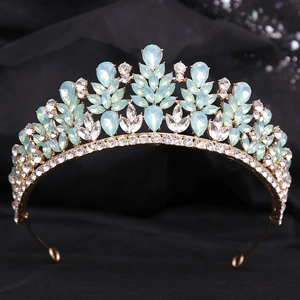 Detailed close-up of golden bridal crown with blue teardrop crystals and small diamonds