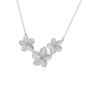 Detailed view of silver necklace featuring three interconnected textured flower petals