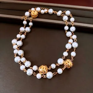 French vintage double-layer necklace with white pearls and hollow golden floral spheres