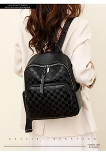 Detailed view of women's black checkered leather backpack with front zipper pocket