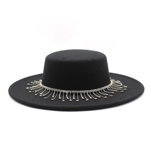 Detail of black wool felt boater hat featuring luxury rhinestone tassel trim and flat brim