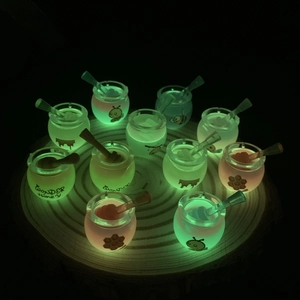 Luminous mini honey jars glowing in the dark on a wooden tray for DIY crafts