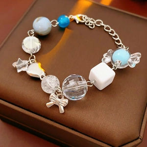 Detailed macro view of beaded bracelet with star charms and candy bow on jewelry box