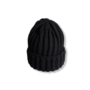 Close-up of black ribbed knit beanie showing high-quality vertical texture and folded cuff