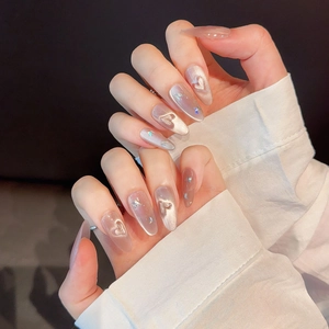 Pink cat eye press-on nails in long almond shape with 3D white hearts and star glitters