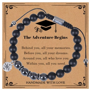 Detail of matte zebra stone beads with compass charm on adventure gift card