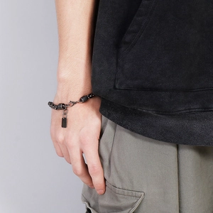 Detail of men's gunmetal punk chain bracelet with industrial interlocking link design