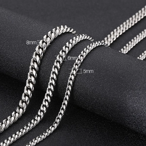 Three silver stainless steel Cuban link chains in 5mm, 6mm and 8mm widths on dark background