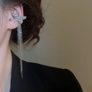 Detailed side view of silver butterfly ear cuff with shimmering zircon tassel chains